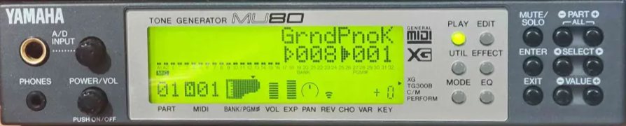 A photo of a “Yamaha MU80” “Tone Generator”. This is a half-rack unit, 1U high, similar in size to the SC-55mkII or SC-88VL, but with a very different design language. It has a highly premium look-and-feel, with some of the facade being dark gray plastic, but with an lighter inset zone that looks more like it might be metal. There is a large backlit black-on-green LCD front-and-center, which displays a similar bar-graph-like visualisation of musical parts to the Sound Canvas series. However, the screen dedicates a lot more screen space to the patch name and distinctive visualisations of the currently selected part's MIDI numbering, volume and expression level, panning position and effect send levels (of which there are three: Reverb, Chorus, and Variation). It even displays a small, quite crude and low-resolution pixel-art illustration to represent a Grand Piano. Beyond the screen, there are among other things, prominent “General MIDI” and “XG” logos, a large gold-rimmed quarter-inch “A/D input” jack, a 3.5mm “Phones” jack, and a few buttons for selecting which parameter to edit and so on.